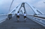 TOYOTA CITY. TOYOTA BRIDGE - due giovani ragazze giapponesi attraversano il ponte in bicicletta sfruttando i percorsi laterali