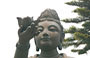 LANTAU. Il bel volto di una statua in bronzo di bodhisattva che offre doni al Grande Buddha del Monastero di Po Lin