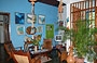 CHORONI'. Le piante, i pappagalli in legno e la parete azzurra contribuiscono a creare un tocco caraibico in questo piacevole angolo <em>parlour</em>