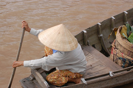 CAI RANG - Dalla nostra barca fotografiamo una donna intenta a remare con il caratteristico non bai tho