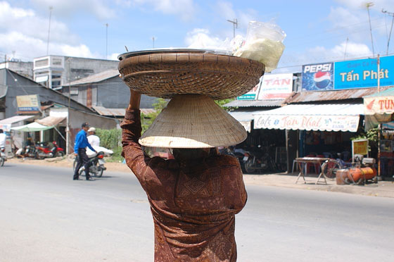 CAI RANG - Una tipica immagine vietnamita: una donna con il non bai tho porta un cesto in testa